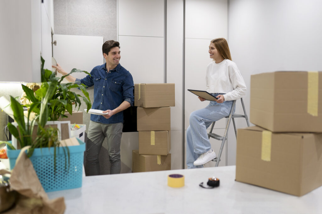 Happy couple unpacking belongings in new home after move with Abu Dhabi moving company